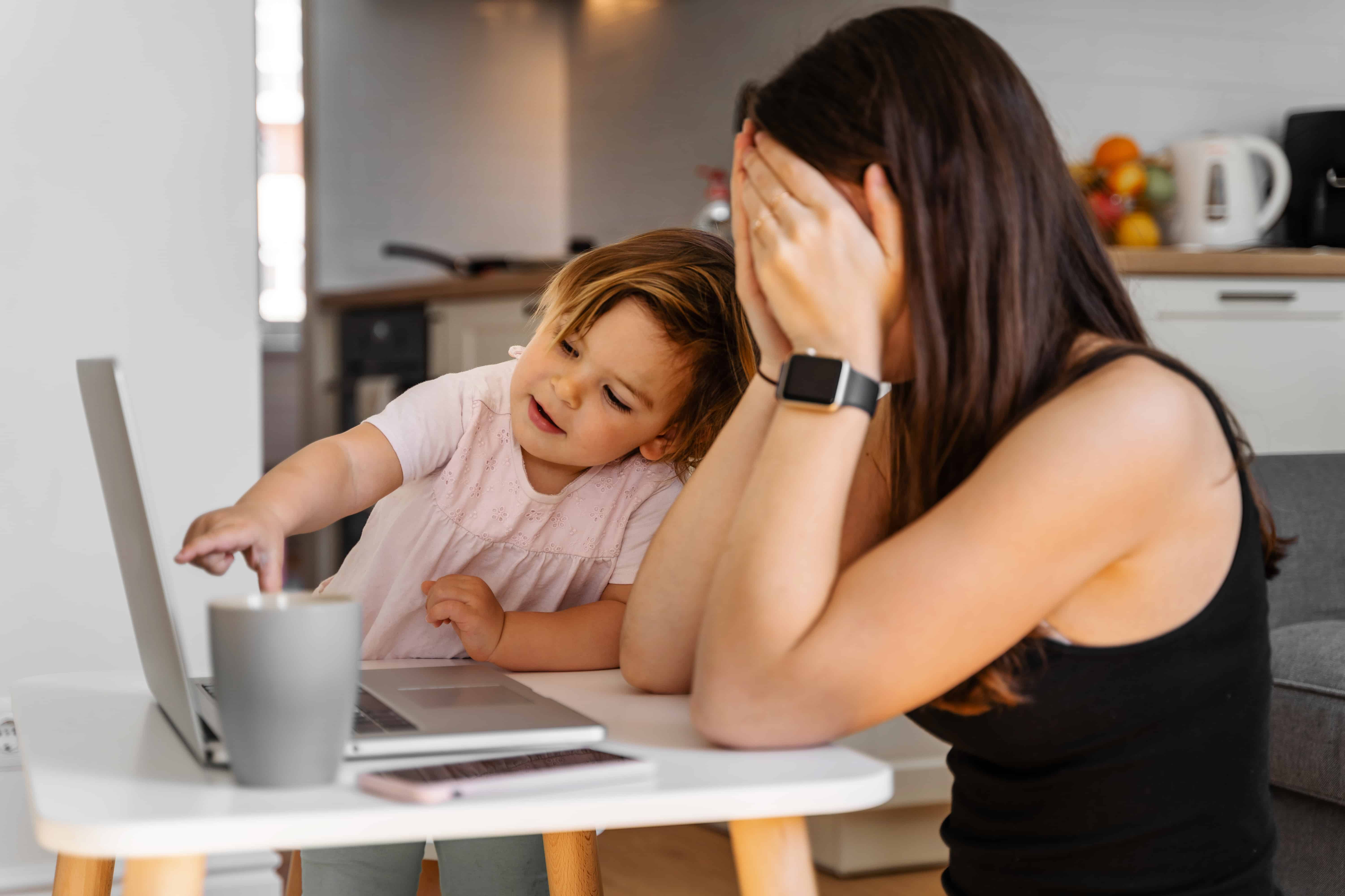 what is parental burnout, signs of parental burnout, stressed mother working at home