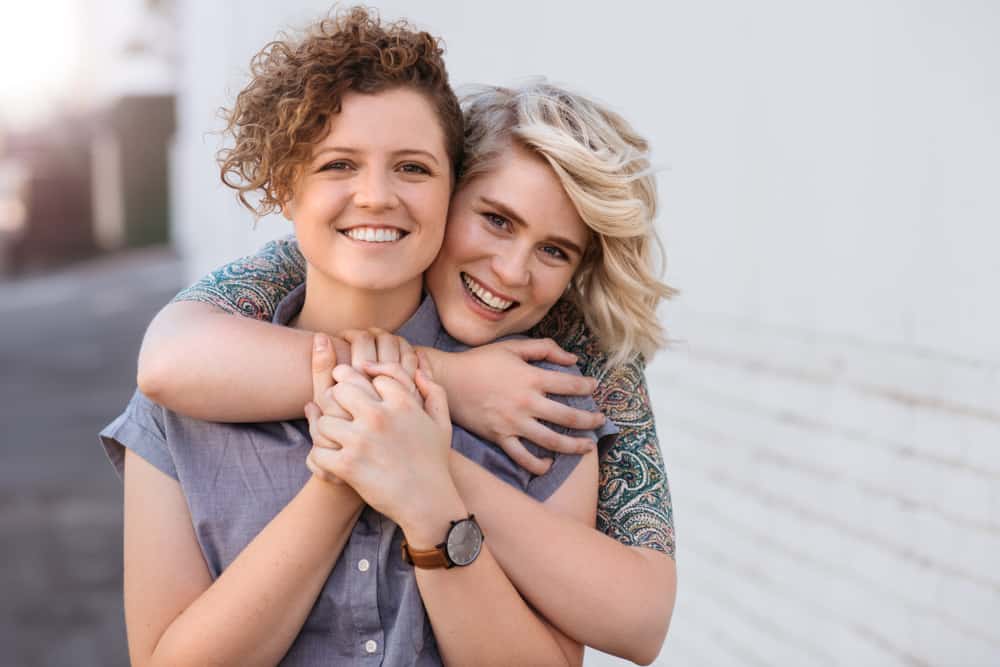 Portrait,Of,A,Smiling,Young,Lesbian,Couple,Hugging,Each,Other