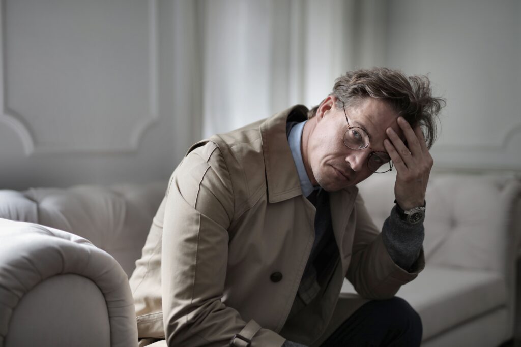 Depression in men: a man sitting alone in an empty courtroom